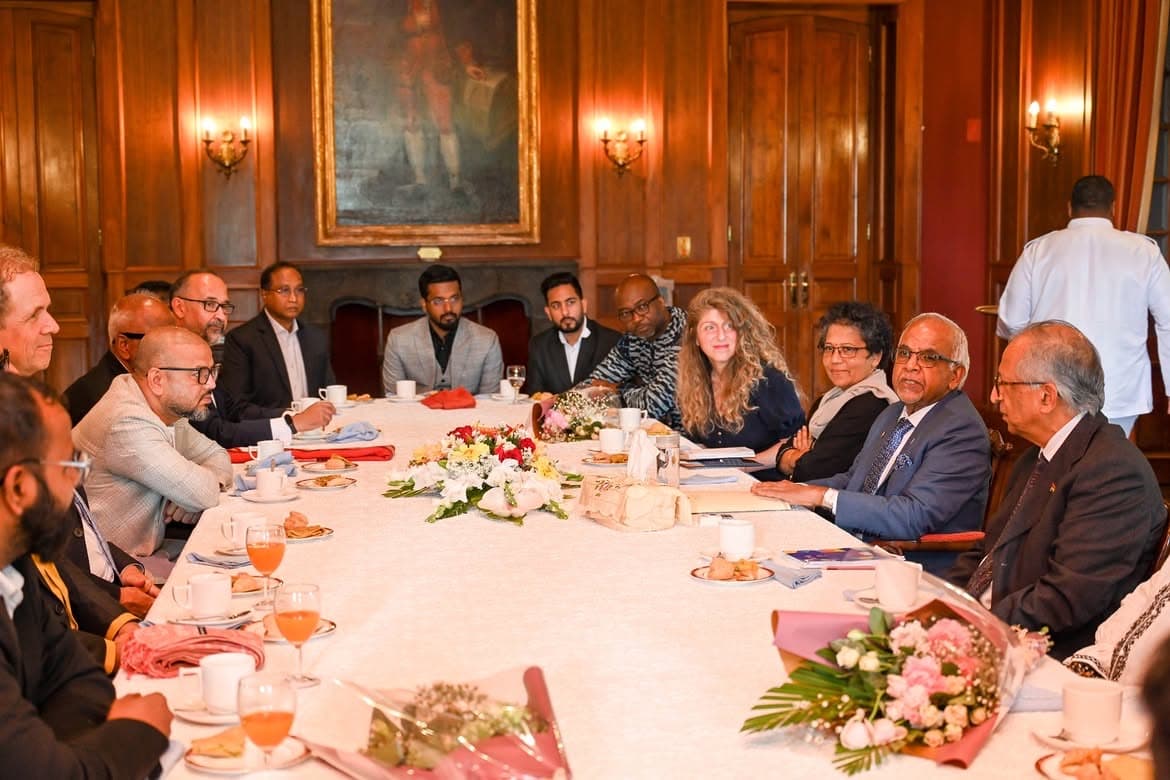 Partners and institutional delegates seated around a roundtable discussion