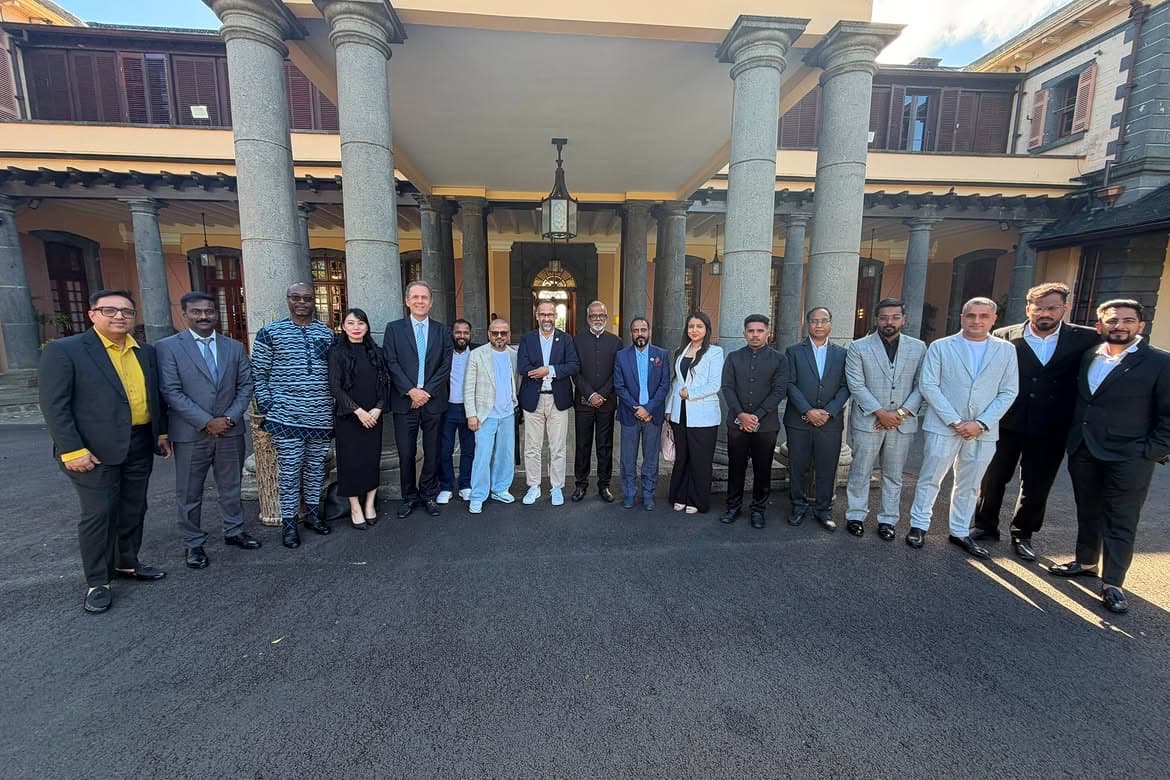 WOI India leadership with an international delegation outside a colonnaded government building